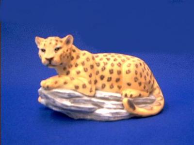 leopard figurine on rock 