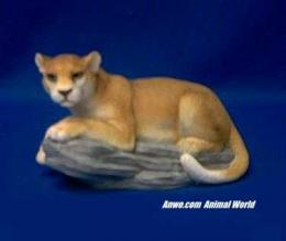 cougar figurine on rock statue