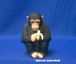 chimpanzee figurine statue holding a banana